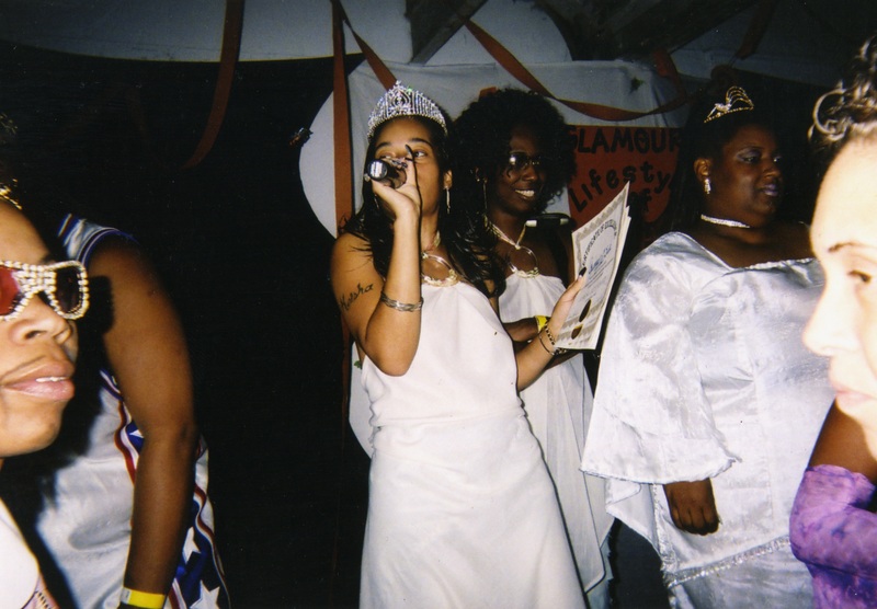 An feminine emcee stands in the middle of a crowd at Soakie's.