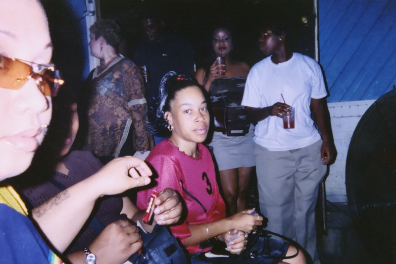 A crowd at Soakie's sit and stand around a couch.