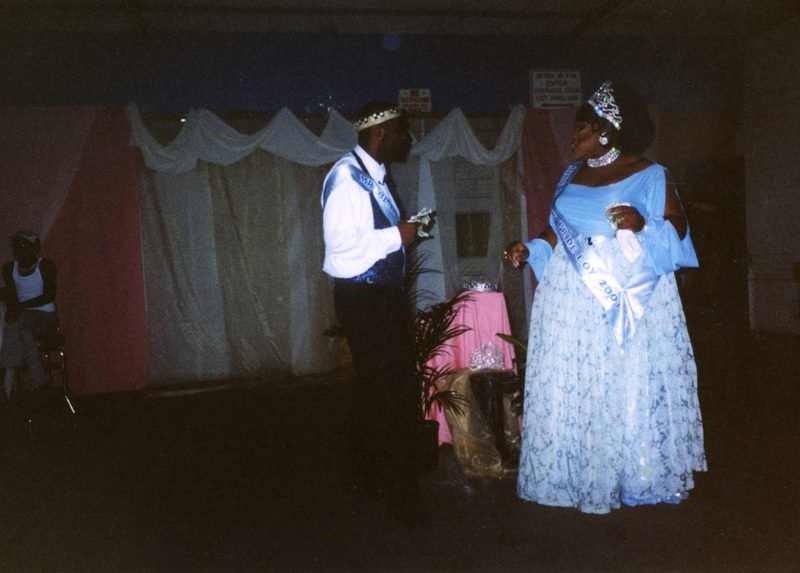 The two winners of "Mr. and Miss Black Gay Pride 2003" look to each other.