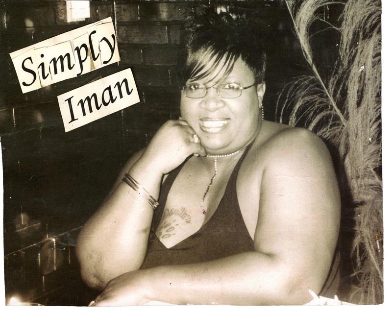 Simply Iman poses in front of a brick wall at Soakie's. There is text dubbing her "Simply Iman". 