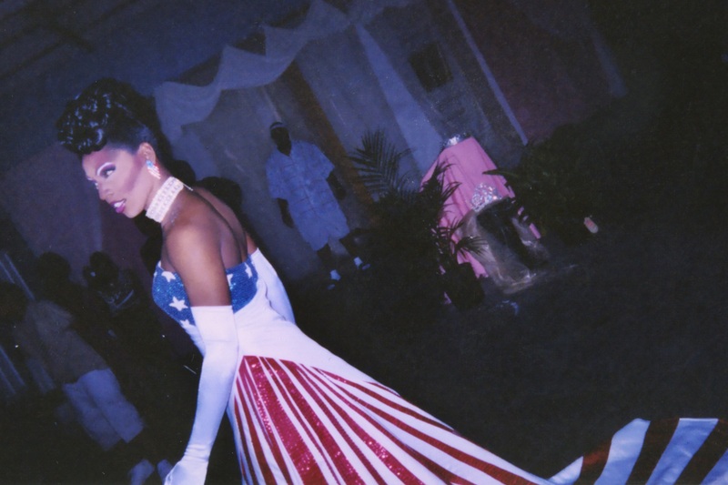A feminine performer at Soakie's looks to the crowd in an American flag-themed dress. 