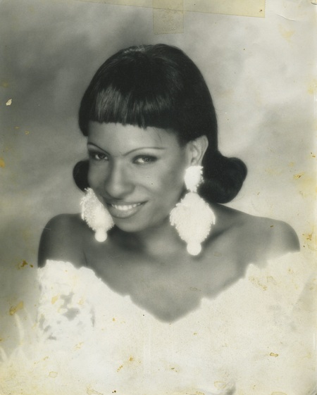 Tisha Taylor smiles in a headshot. The image is in black and white. 